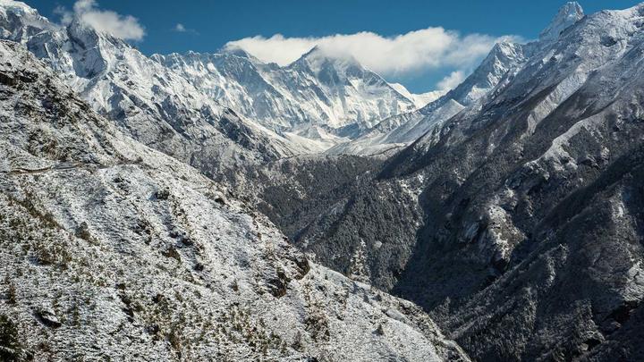 Snow-covered mountain peaks under a clear blue sky